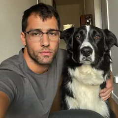 Dog dad taking a selfie with a black and white dog